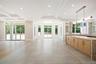Unfurnished living room with beamed ceiling, recessed lighting, coffered ceiling, and a raised ceiling