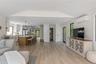 Living area featuring wooden ceiling, an AC wall unit, light wood finished floors, and lofted ceiling