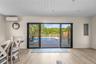 Entryway featuring wood finished floors, electric panel, an AC wall unit, and wooden ceiling