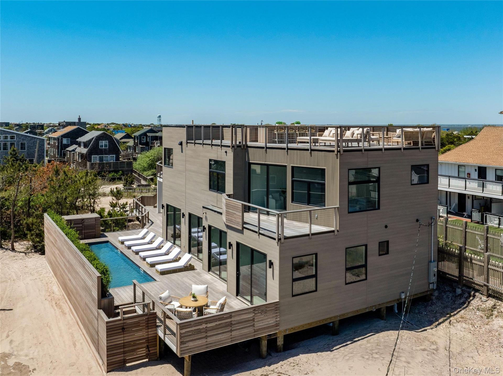 Rear view of property with a wooden deck, a residential view, and an outdoor pool