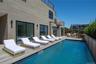 Rear view of property with a deck and outdoor dining space