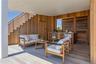Living area featuring wooden walls, light wood-type flooring, and wooden ceiling