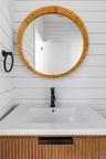 Bathroom with vanity and wooden walls