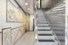 Stairs with tile walls and recessed lighting