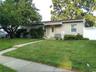 Single story home featuring fence and a front lawn