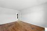 Spare room featuring wood-type flooring and arched walkways