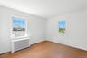 Spare room with radiator heating unit and light wood-type flooring