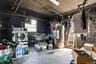 Basement featuring concrete block wall, gas water heater, washer / clothes dryer, and plenty of natural light