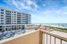Balcony with view of water and beach
