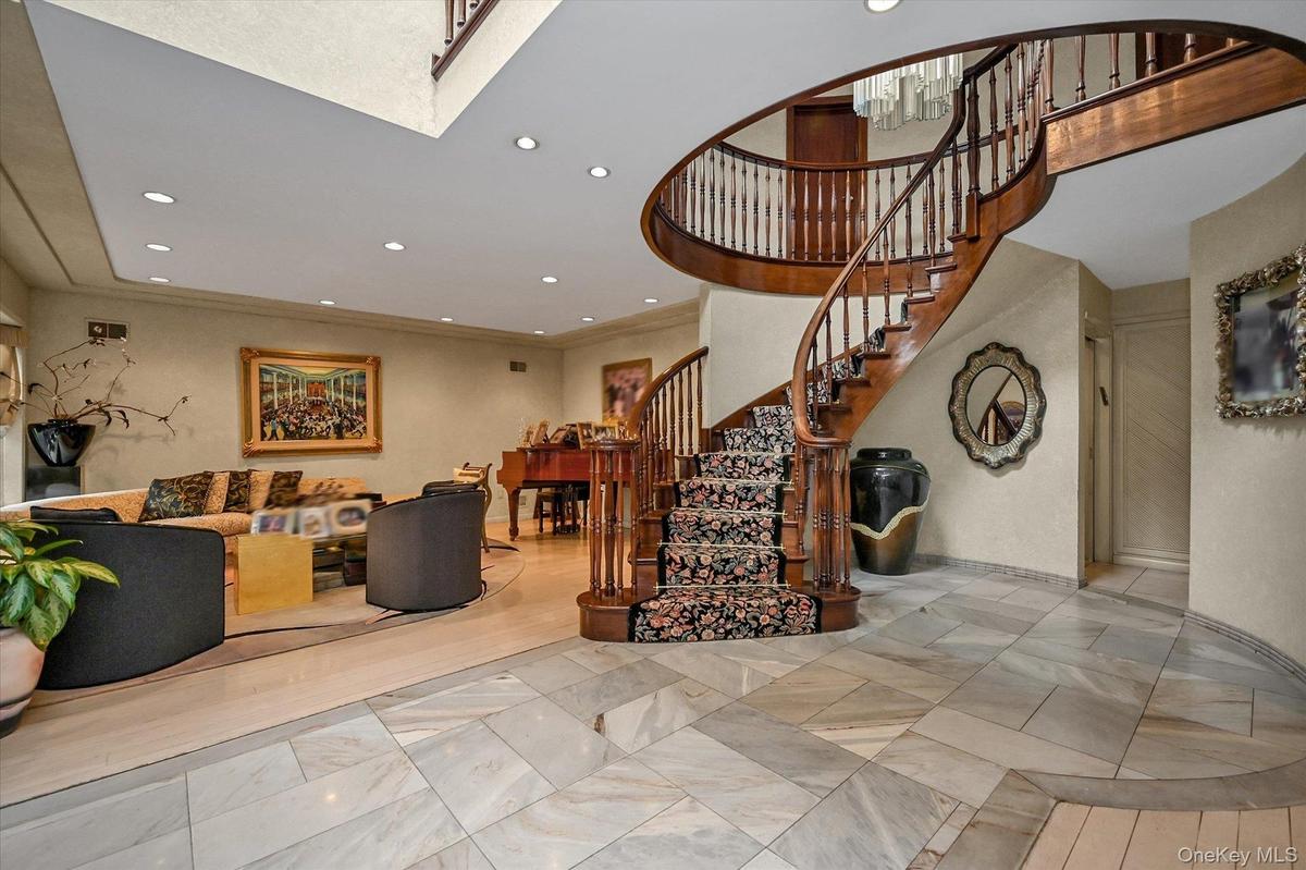 Stairs featuring recessed lighting and a high ceiling