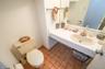 Half bathroom with dark tile patterned flooring and vanity