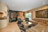 Living room with recessed lighting, light wood-style flooring, and wooden walls