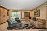 Living room featuring recessed lighting, wood finished floors, and wooden walls