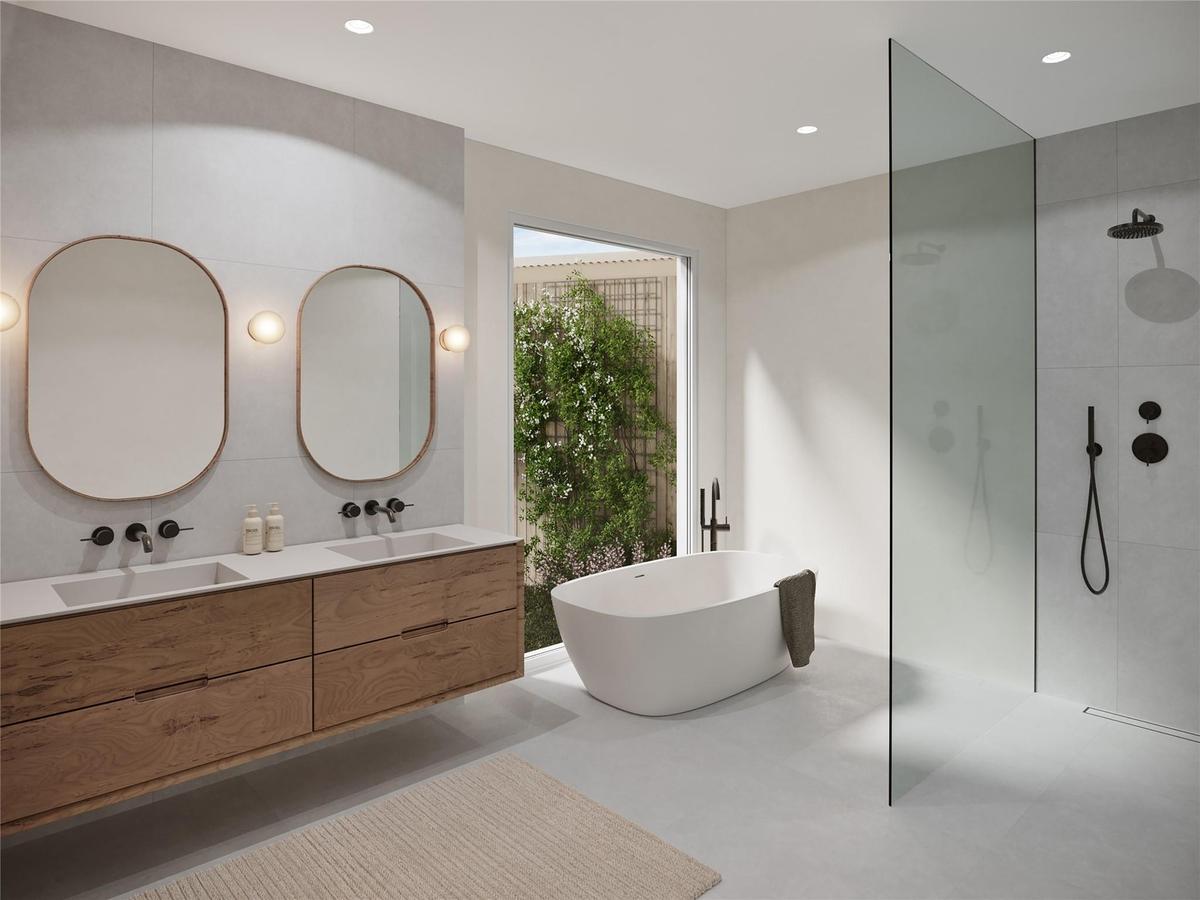 Bathroom featuring double vanity, a walk in shower, a soaking tub, and recessed lighting
