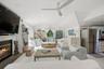 Living area featuring vaulted ceiling, recessed lighting, a glass covered fireplace, and ceiling fan