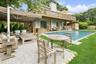 Back of house featuring outdoor lounge area, a patio area, and a chimney
