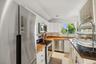 Kitchen featuring appliances with stainless steel finishes, white cabinetry, lofted ceiling, recessed lighting, and wooden counters