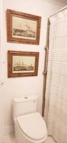 Bathroom with toilet and a shower with curtain
