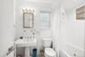 Bathroom with tile walls and shower / bath combination with curtain