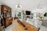 Dining room with a glass covered fireplace, ceiling fan, recessed lighting, and a chandelier