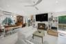 Living room featuring recessed lighting, a glass covered fireplace, an AC wall unit, a chandelier, and ceiling fan