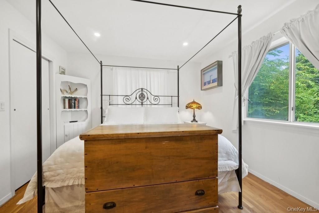 Bedroom with wood finished floors and recessed lighting