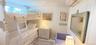 Bedroom with wood walls and an AC wall unit