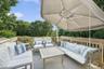 Wooden terrace with outdoor lounge area and view of scattered trees