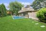 Back of house with a patio area, a yard, crawl space, a chimney, and an outdoor pool
