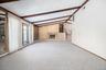 Large Living Room imported stone fireplace, a textured slanted ceiling, with decorative beams.