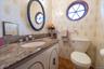 Powder Room with decorative tile walls and Granite vanity.