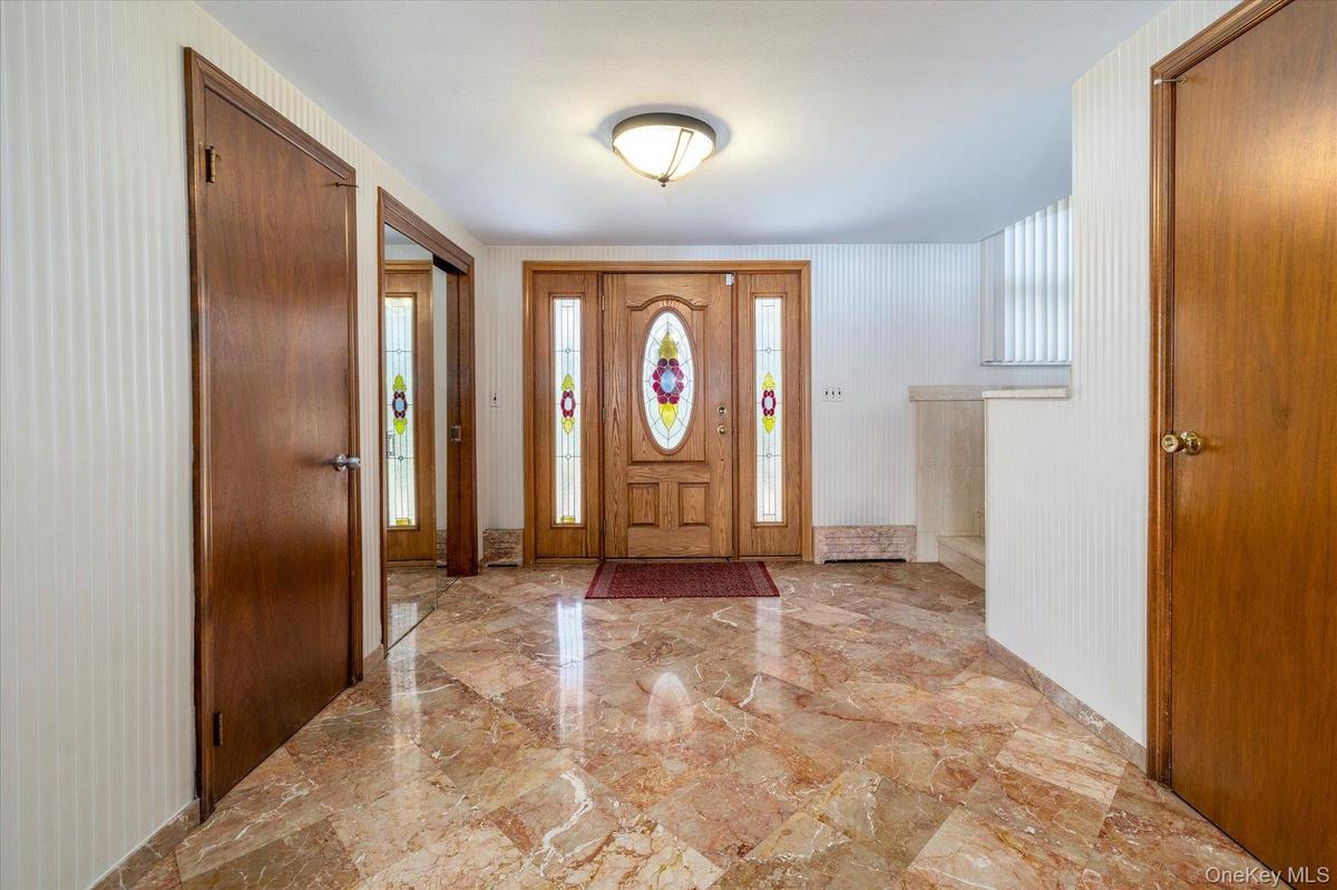 Entrance Foyer featuring marble tiled floors.