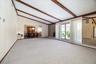 Comfortable Living Room with adjoining Dinning Room, Chandelier, and custom Floors.