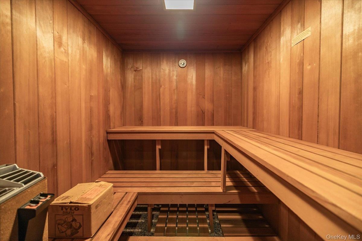 Sauna featuring wood walls and wooden ceiling.