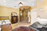 Bathroom with vanity, ornamental molding, a shower stall, a bath, and recessed lighting