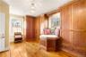 Sitting room featuring light wood-style flooring, a chandelier, and crown molding