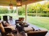 View of patio / terrace with view of wooded area, a water view, and outdoor lounge area
