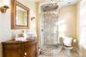 Full bath with vanity, a shower stall, and a chandelier