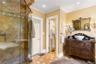 Full bath with a shower stall, vanity, crown molding, and recessed lighting