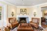Living area featuring ornamental molding, wood finished floors, and a fireplace