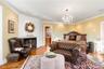 Bedroom with a chandelier, ornamental molding, wood finished floors, and a lit fireplace