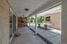 View of Rear covered Patio with year-round outdoor Gas Grill and Granite outdoor table.