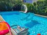 Outdoor pool featuring a water slide.