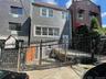 View of front of property with a fenced front yard and a gate