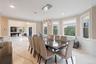 Dining room with light marble finish flooring, ornamental molding, a chandelier, wainscoting, and recessed lighting