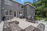Back of property with a patio, outdoor dining space, and brick siding