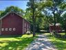 View of side of property with a yard and driveway