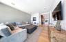 Living area with light wood-style floors and recessed lighting