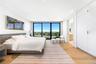 Bedroom featuring floor to ceiling windows, light wood-style floors, and recessed lighting
