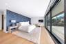 Bedroom featuring wallpapered walls, light wood-type flooring, an accent wall, recessed lighting, and access to outside